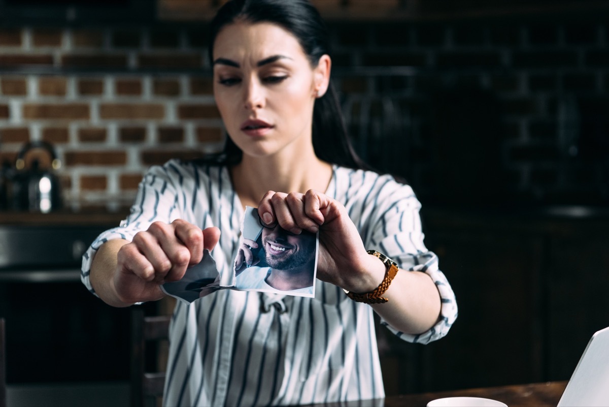 woman tearing a photo