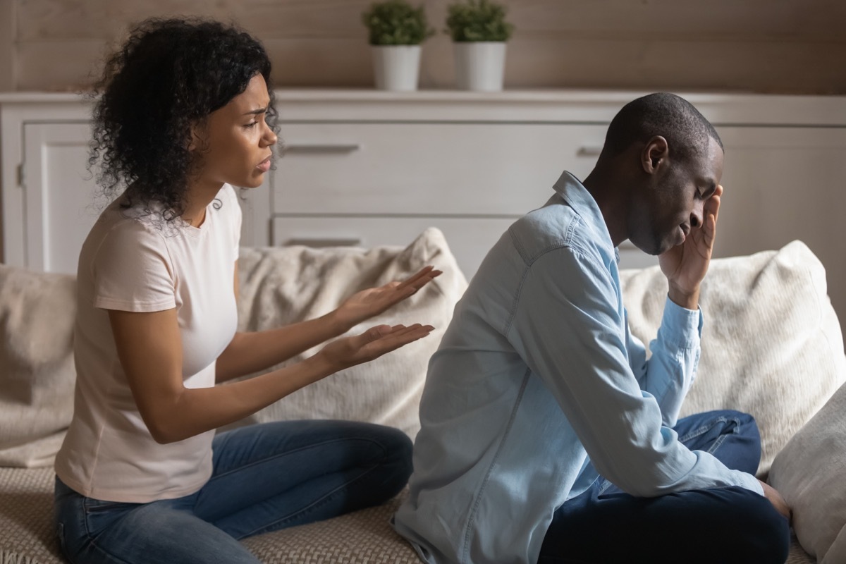 Stressed young woman saying sorry after quarrel to frustrated husband.