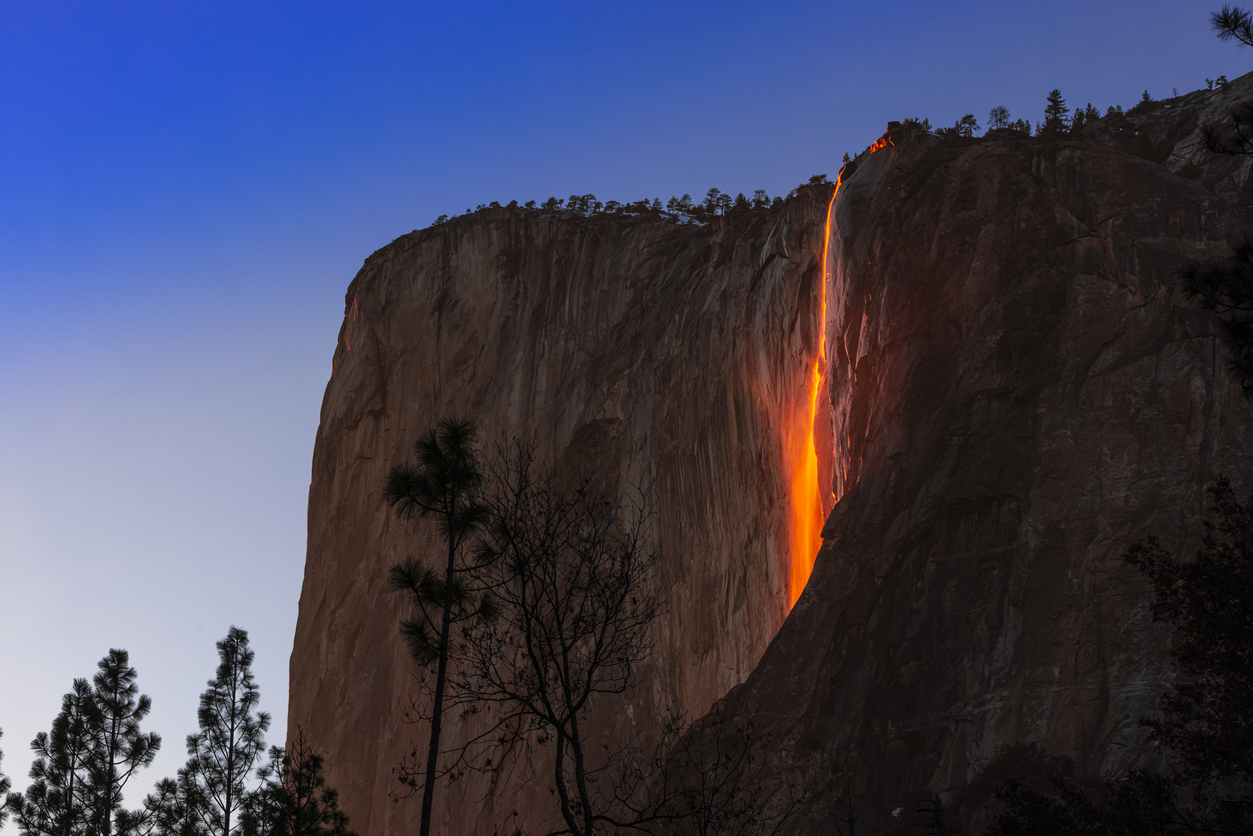 A view of Horsetail Waterfall in Yosemite glowing due to firefall