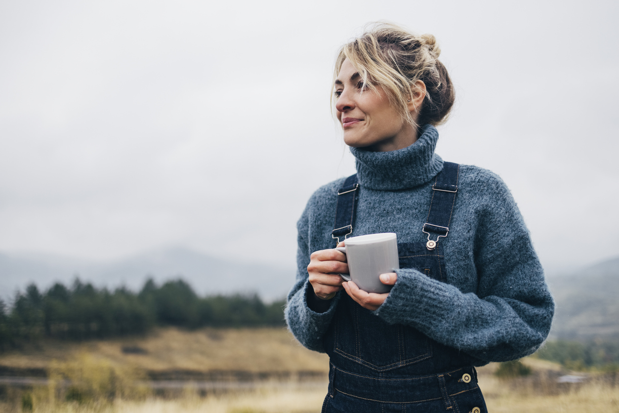 Young woman enjoying her cup of tea outdoors