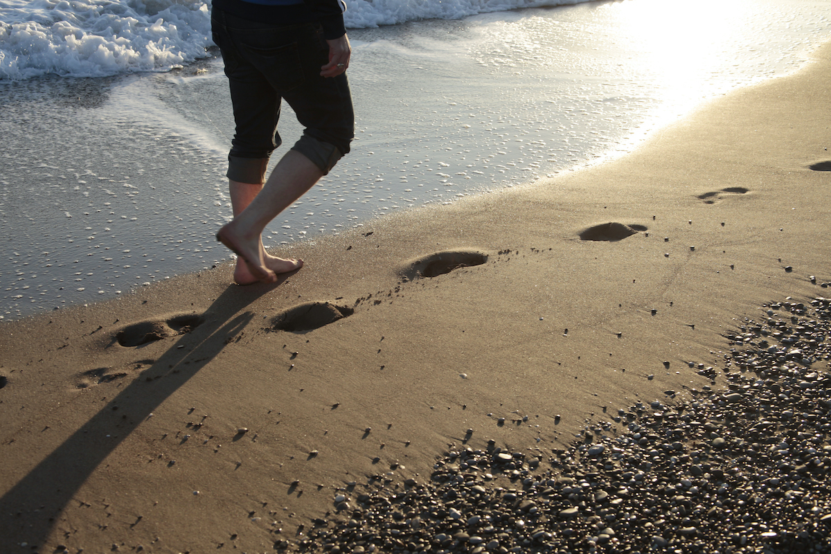 Young man walking on the beach