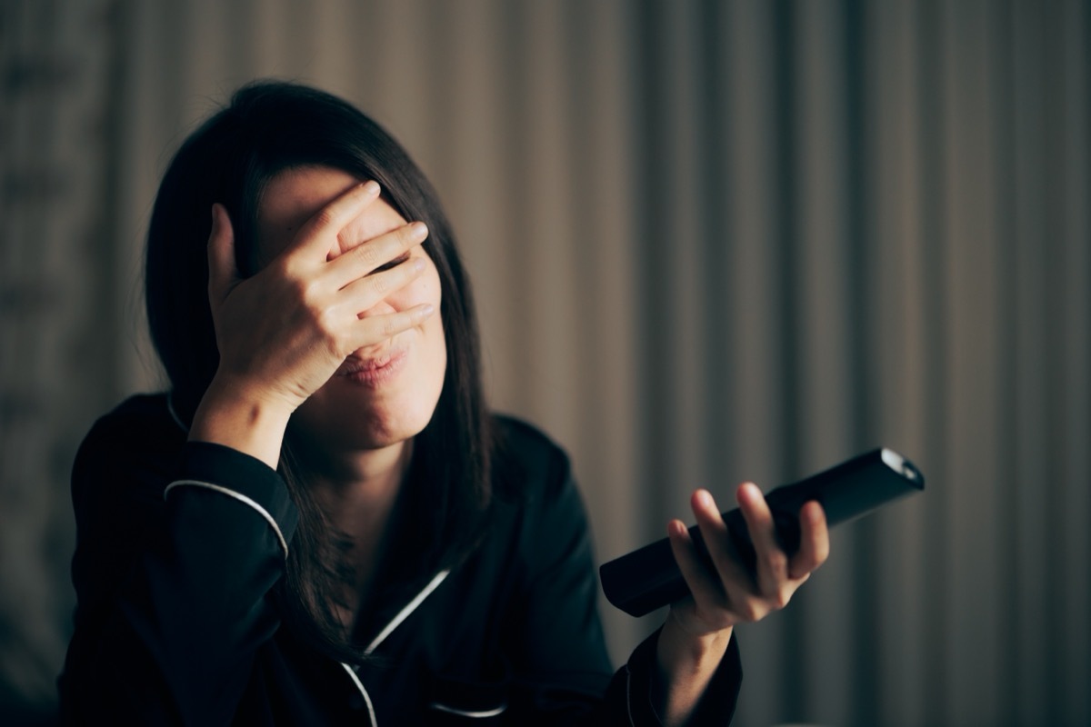 woman frustrated watching tv