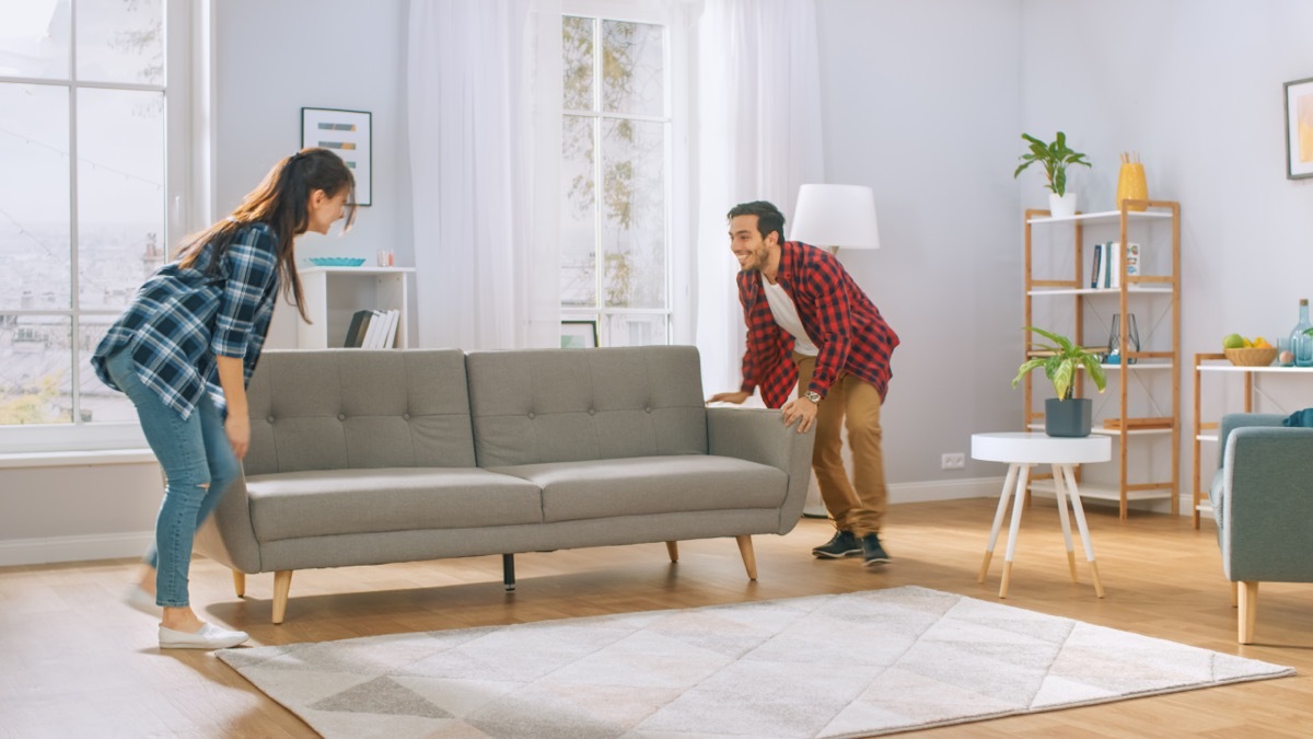 couple rearranging furniture