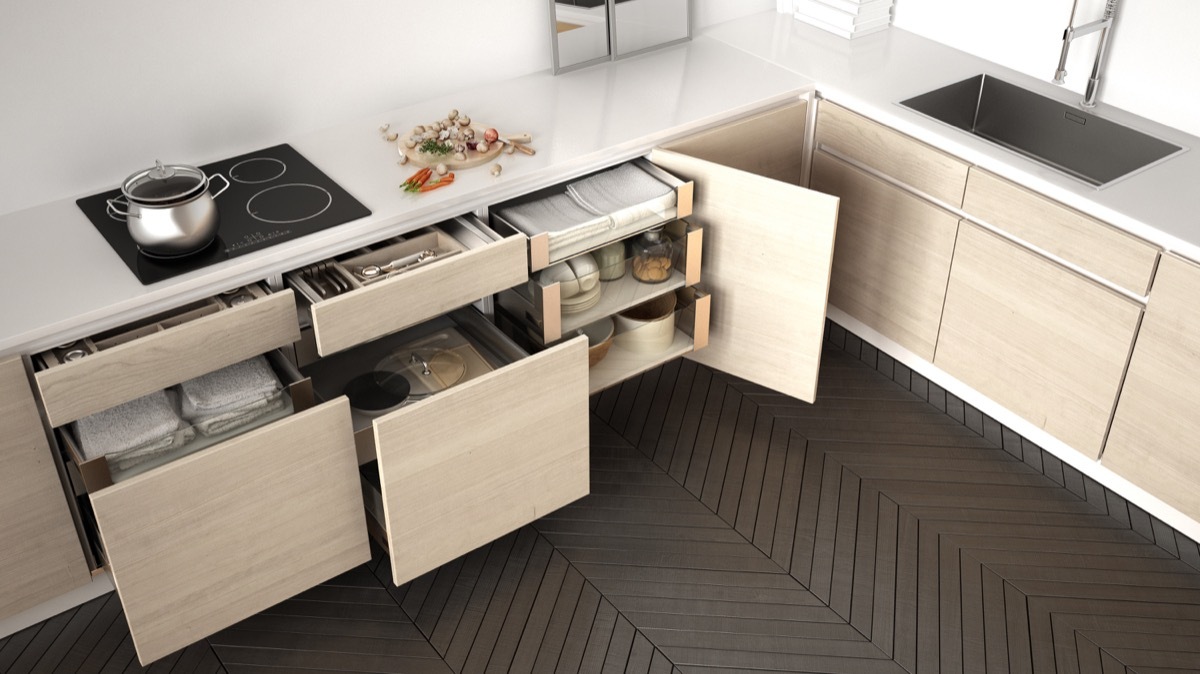 Modern kitchen top view, opened wooden drawers with accessories inside, solution for kitchen storage, minimalist interior design