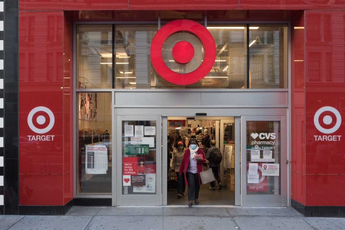 A woman wearing a mask exits a Target store in Midtown.