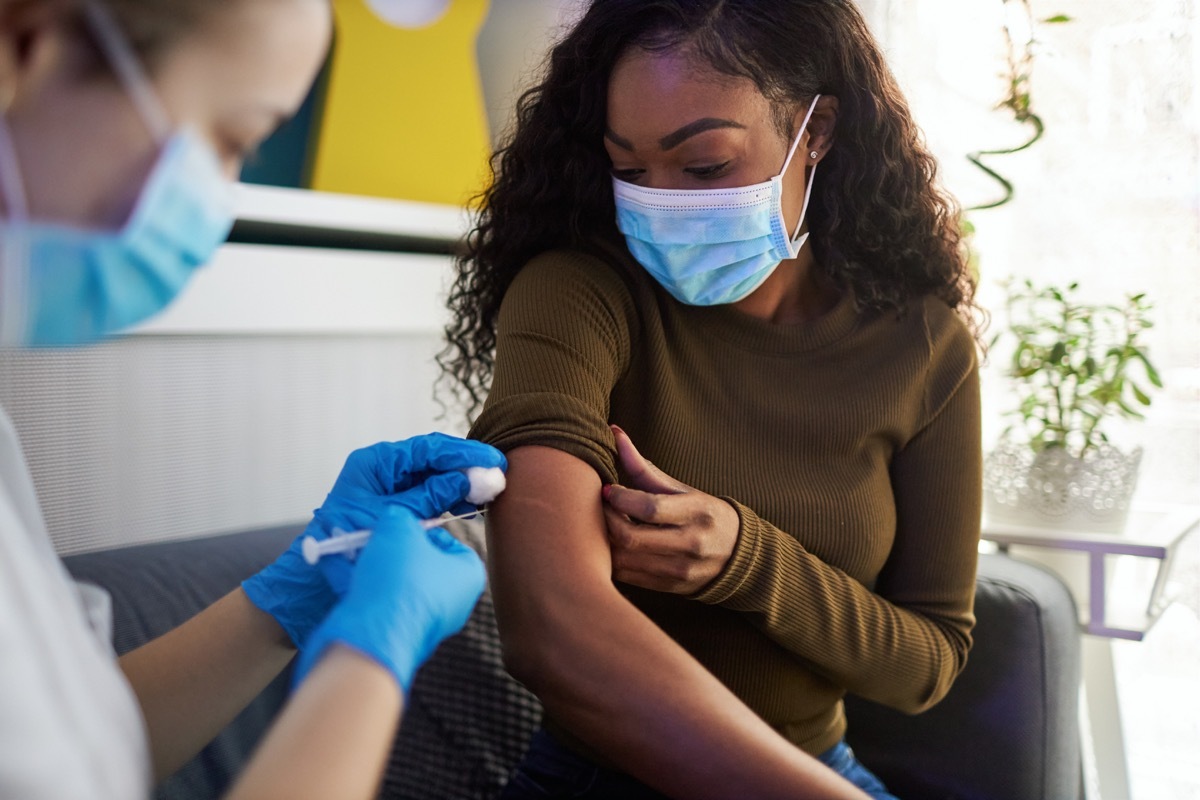 woman gets vaccinated at home during pandemic times.