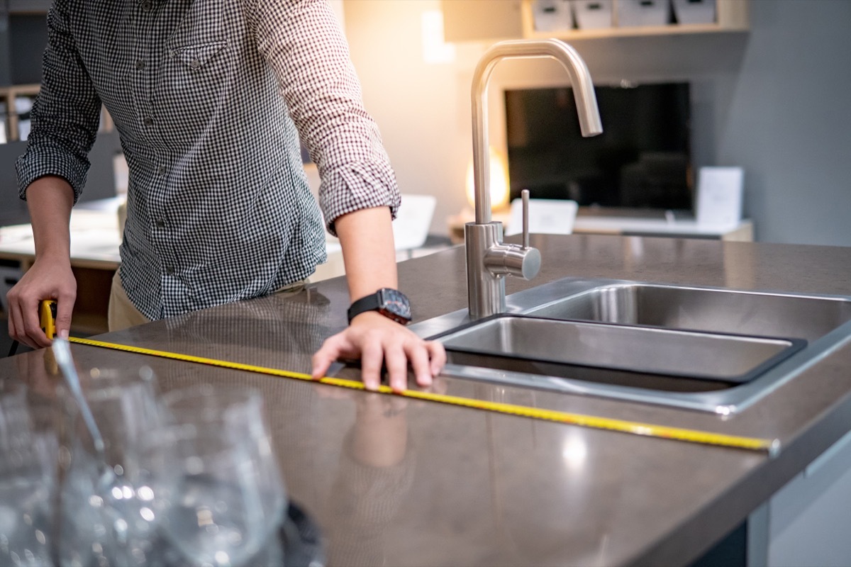 measuring countertop in kitchen