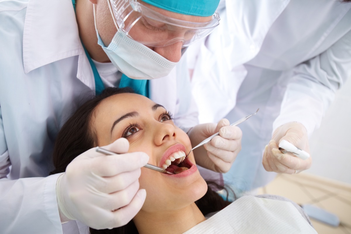 Woman getting her teeth looked at at the dentist's office