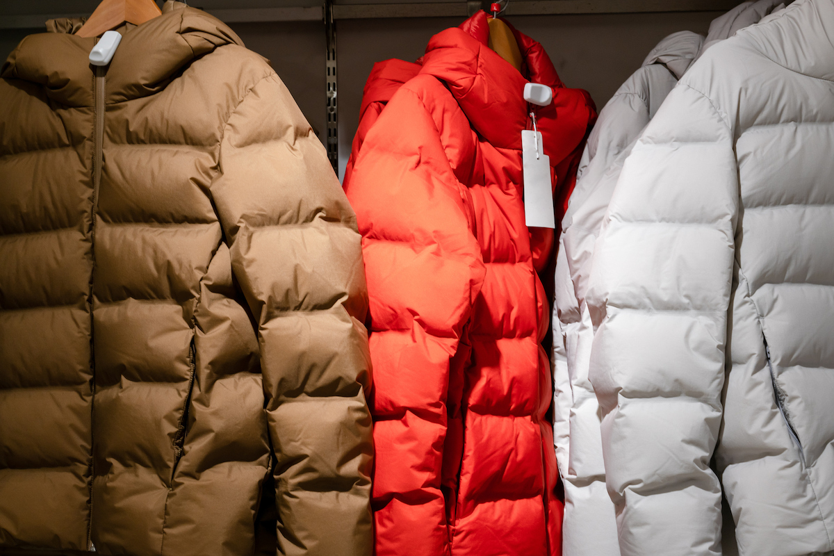 mens puffer coats hanging up