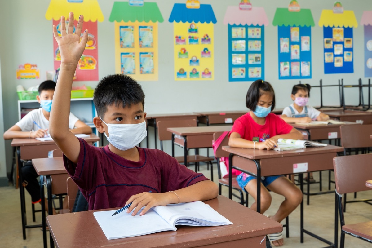 Students socially distanced in class wearing masks during coronavirus pandemic back to school