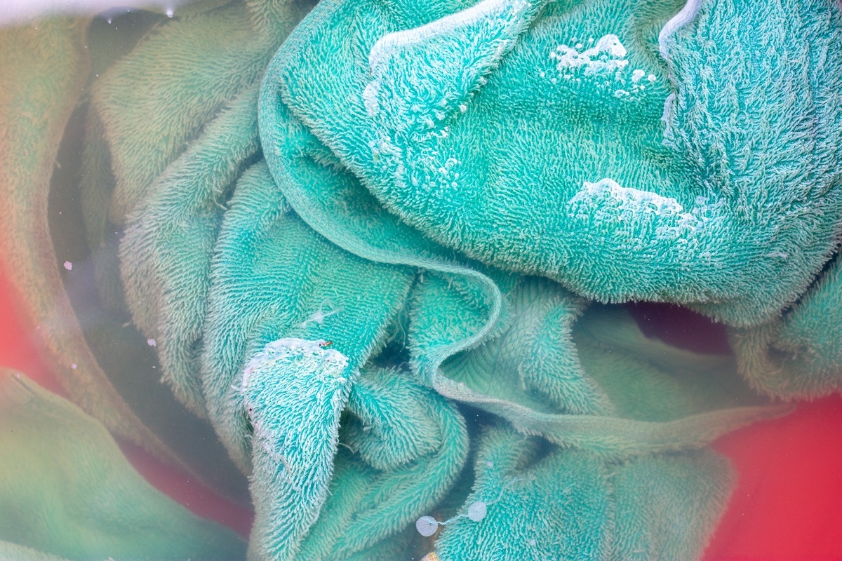 dirty green towel in laundry