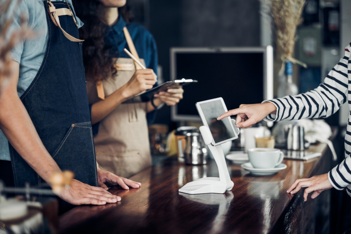 customer self service order drink menu with tablet screen at cafe counter bar,seller coffee shop accept payment by mobile