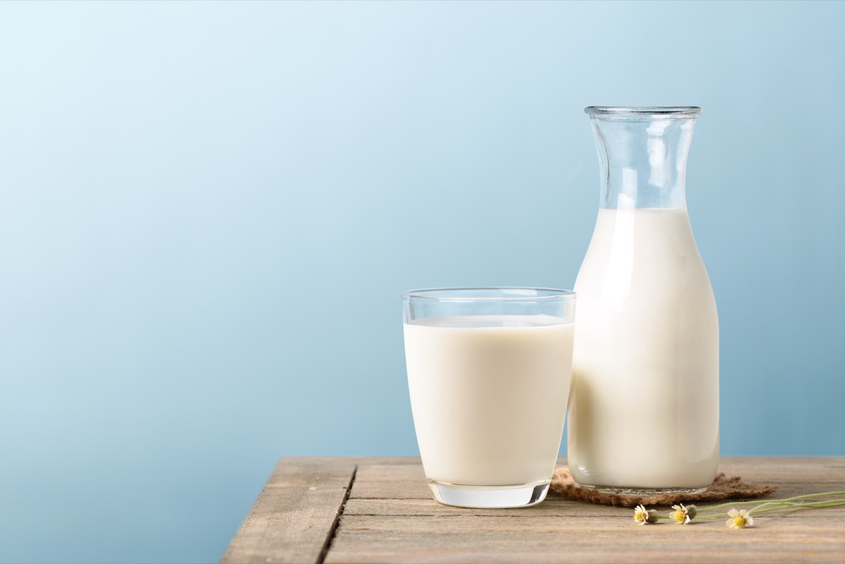 Glass and Pitcher Of Milk on a Table