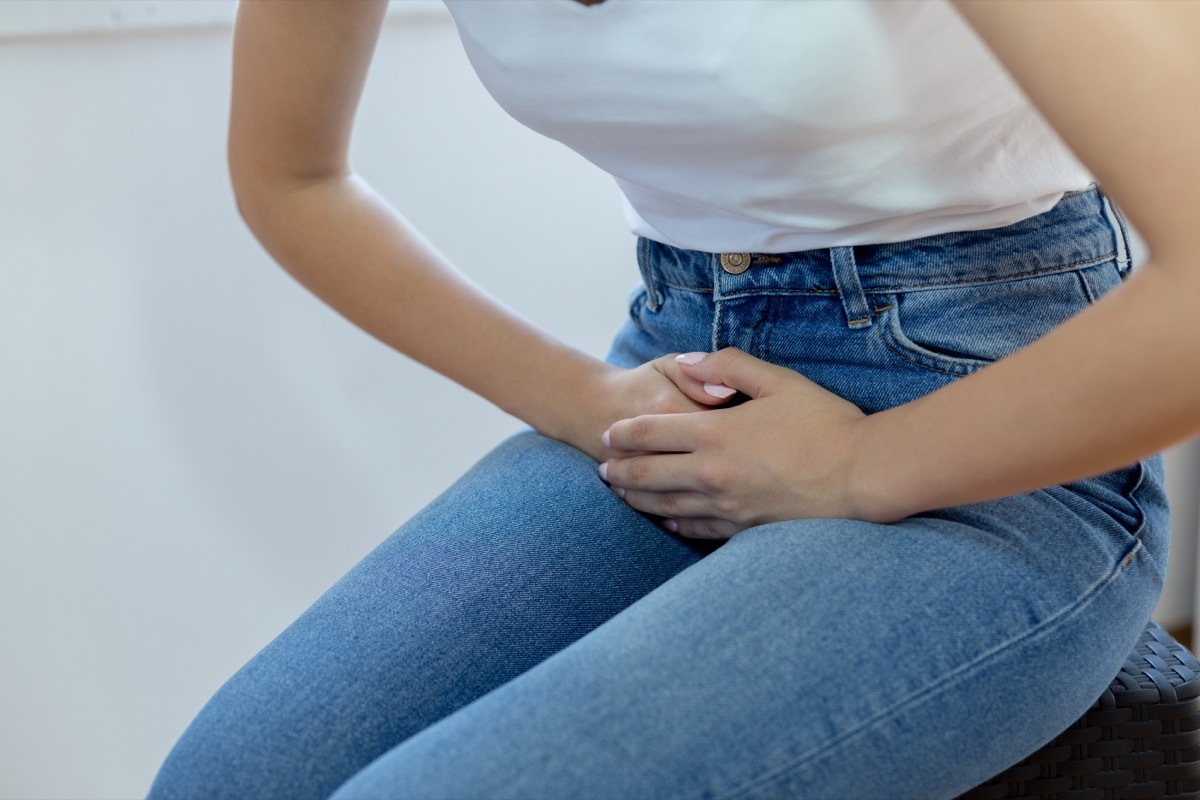 Woman holding her bladder in pain