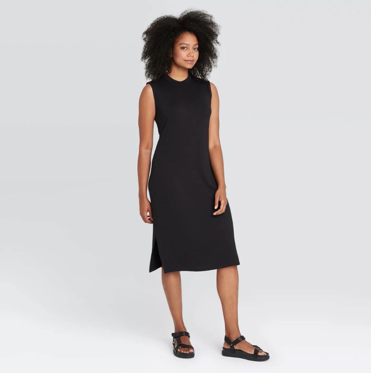 young black woman in black sheath dress