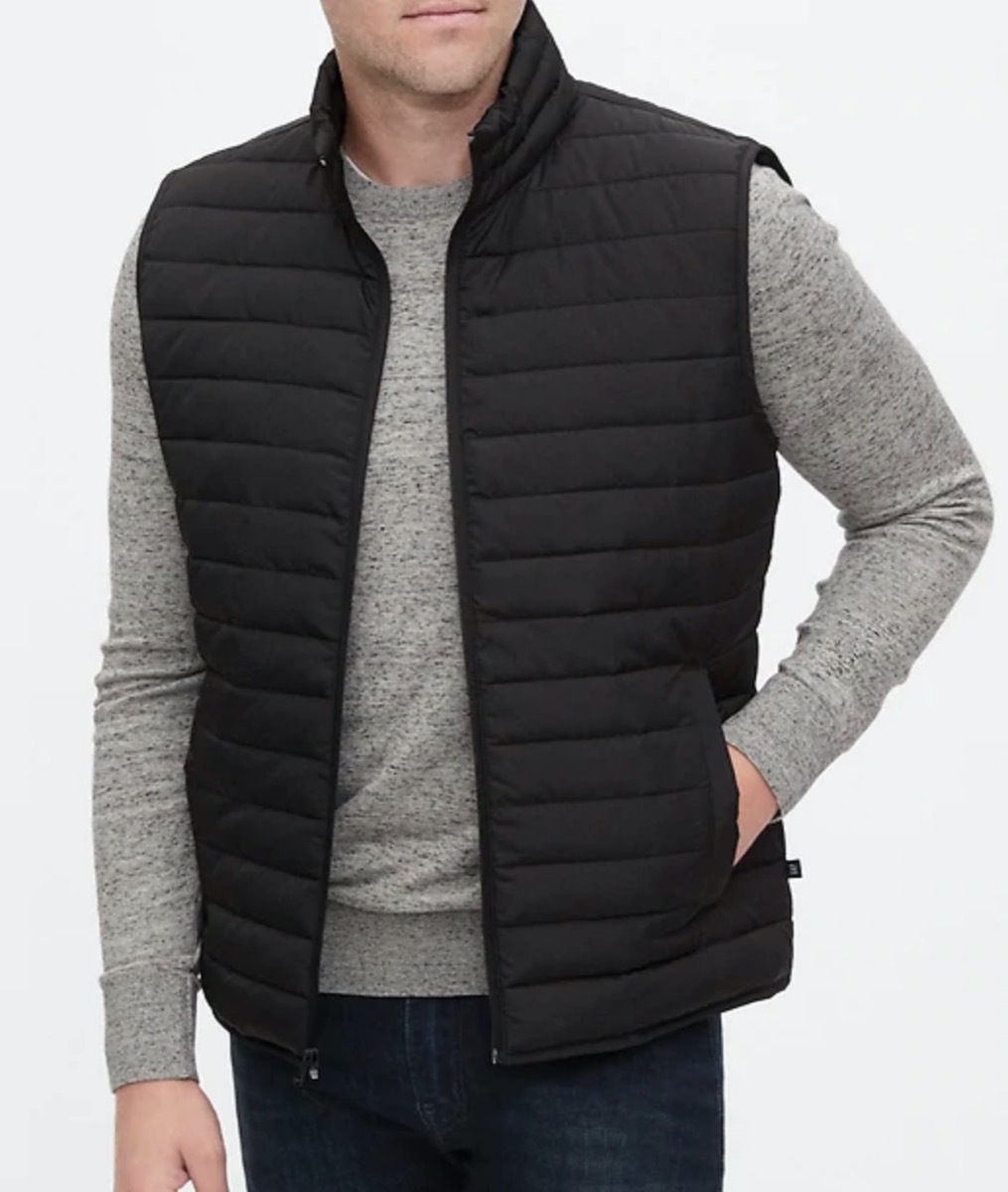 man in gray shirt and black puffer vest