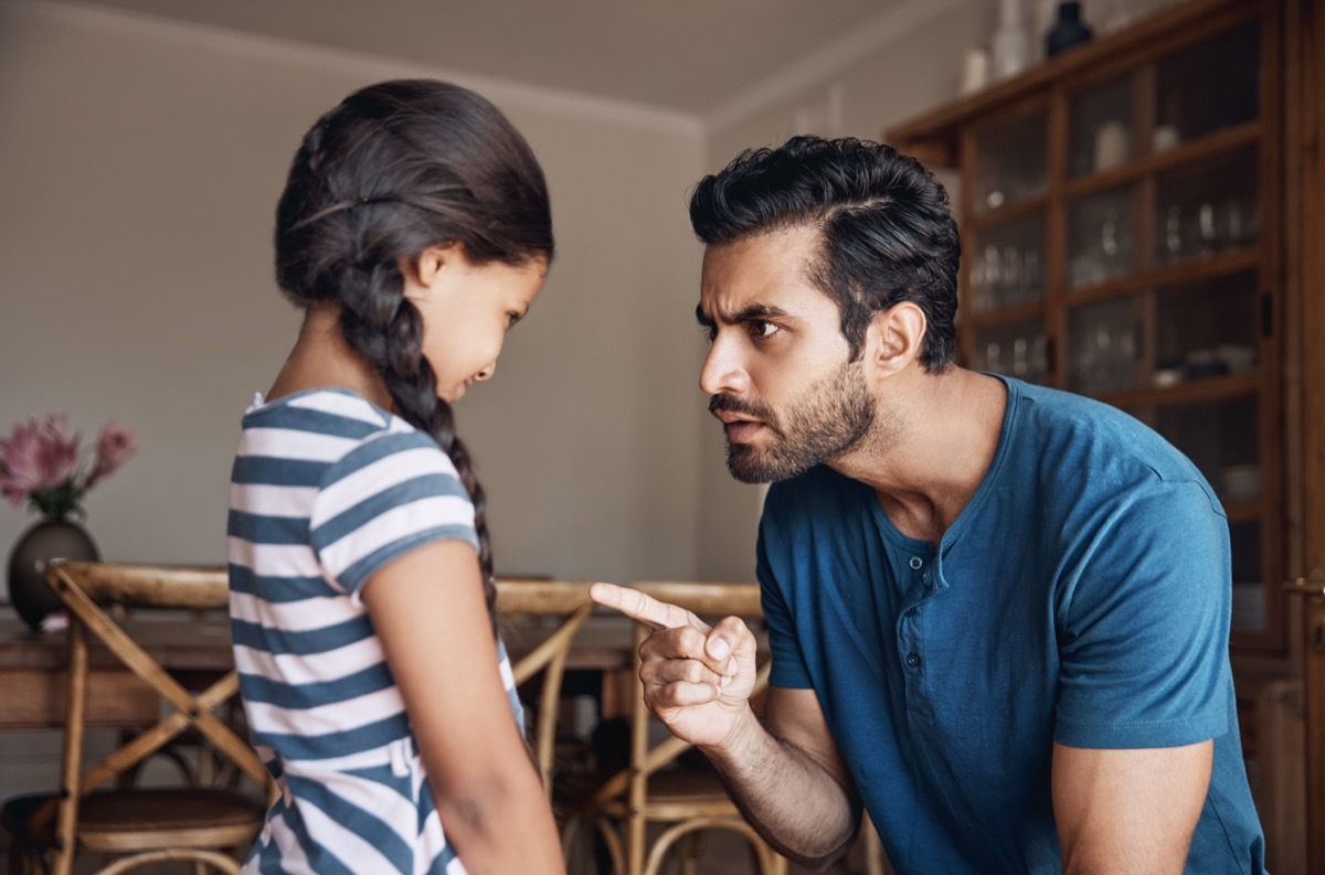 shot of father scolding his young daughter