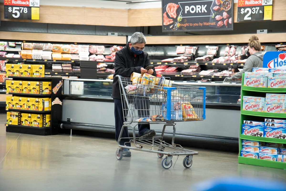 Illinois, United States, - April 10th 2020: A Walmart customer ina face mask attempting to get groceries during the pandemic.