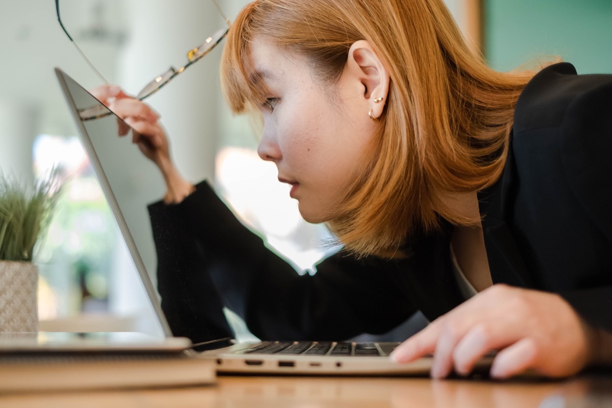 young woman looking at laptop