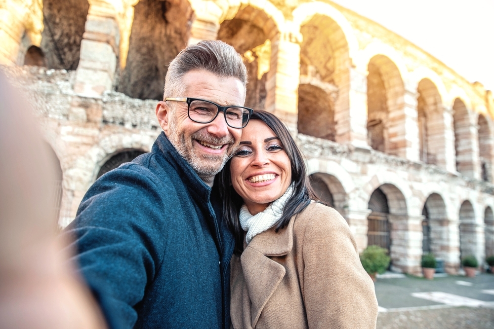 Happy married couple of tourists taking selfie photo smiling