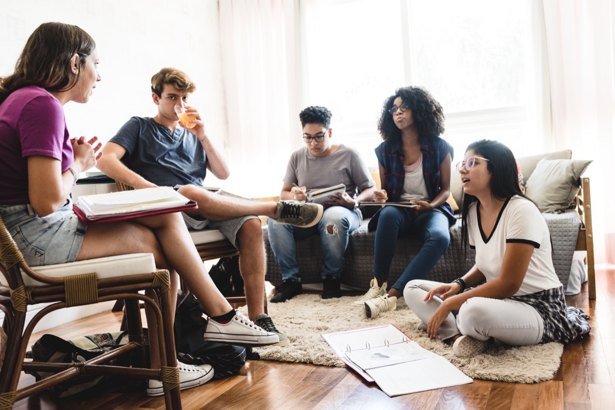 teenager in a group studying with books