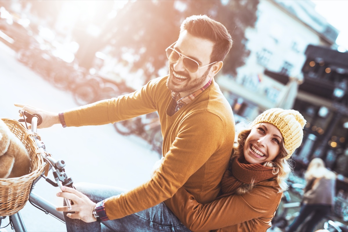 Man and woman riding a bike