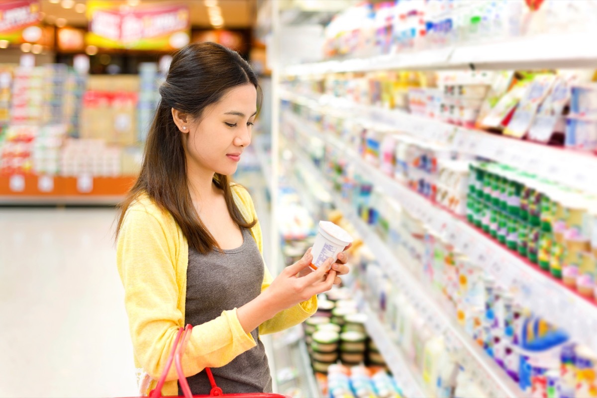 woman buying yogurt in the grocery store