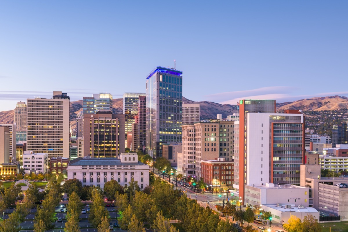 cityscape photo of trees, buildings, and brown mountains in Salt Lake City, Utah