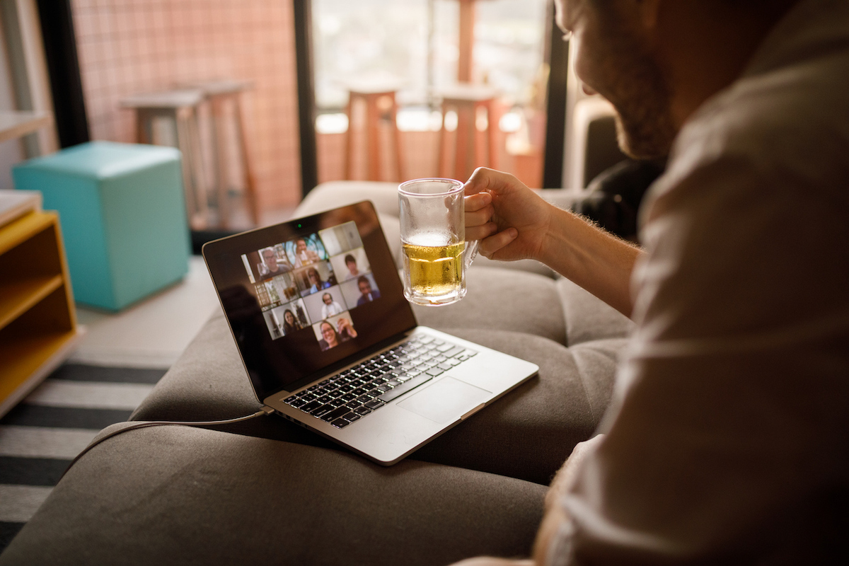 Man hanging out with friends on a video call, potentially celebrating the Super Bowl.