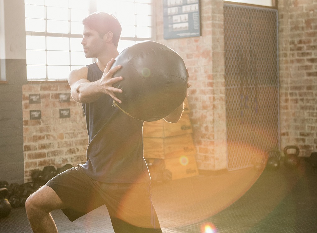 man exercising with a medicine ball