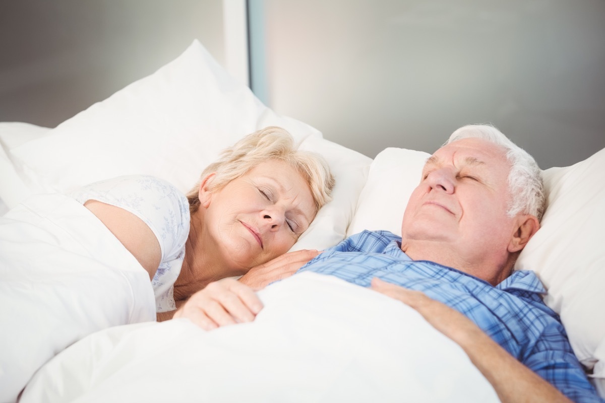 Senior couple sleeping in bed