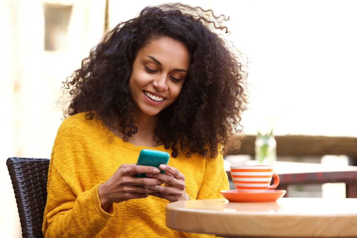 woman reading a text message on her phone