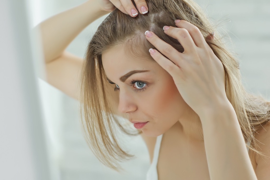 woman looking in mirror