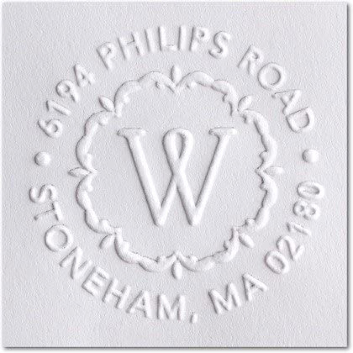 Hand embossed monogram and address