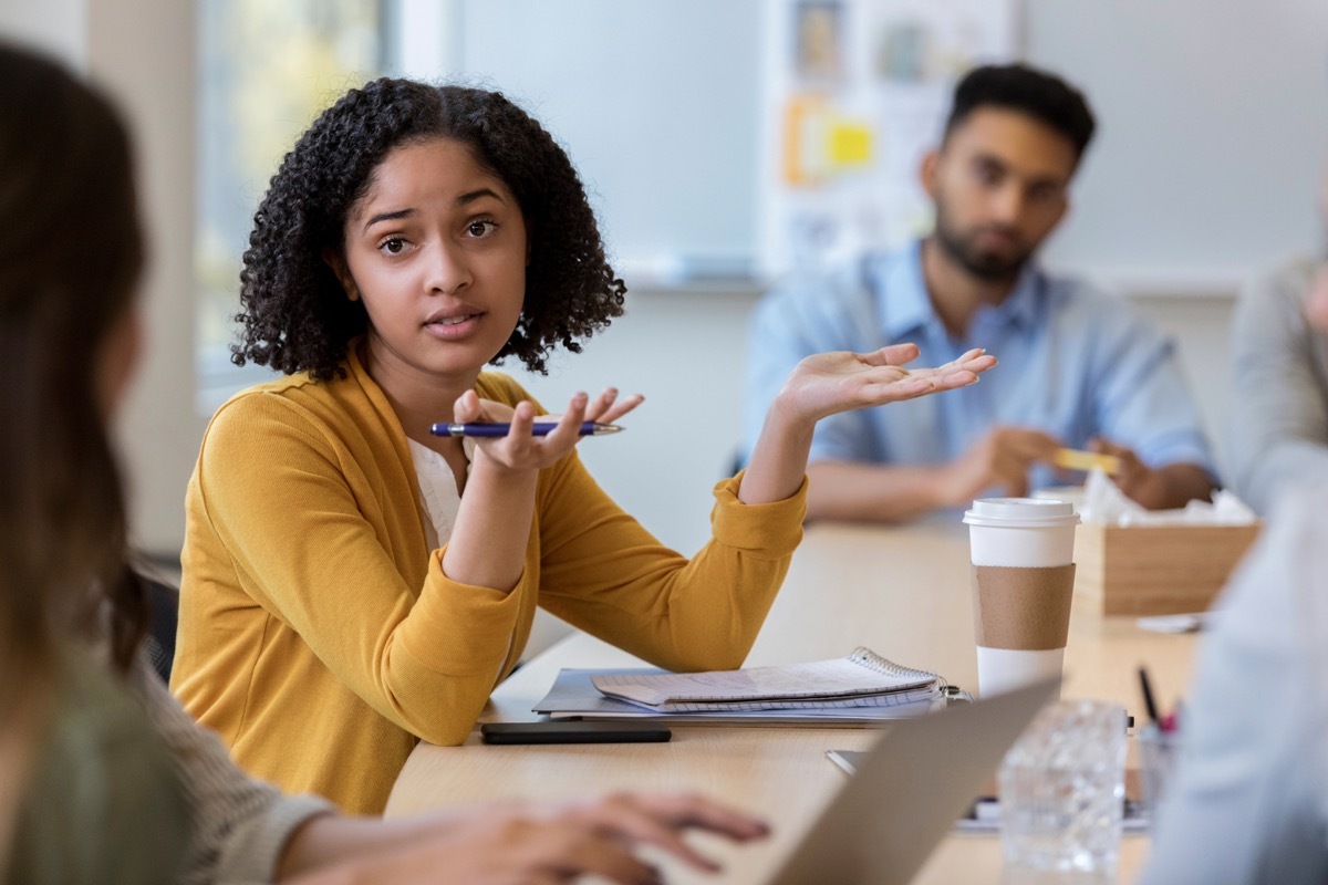 At the annual meeting for the company a young adult woman questions the numbers presented by the accounting department