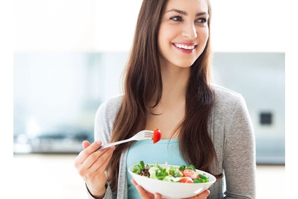 Woman eating salad