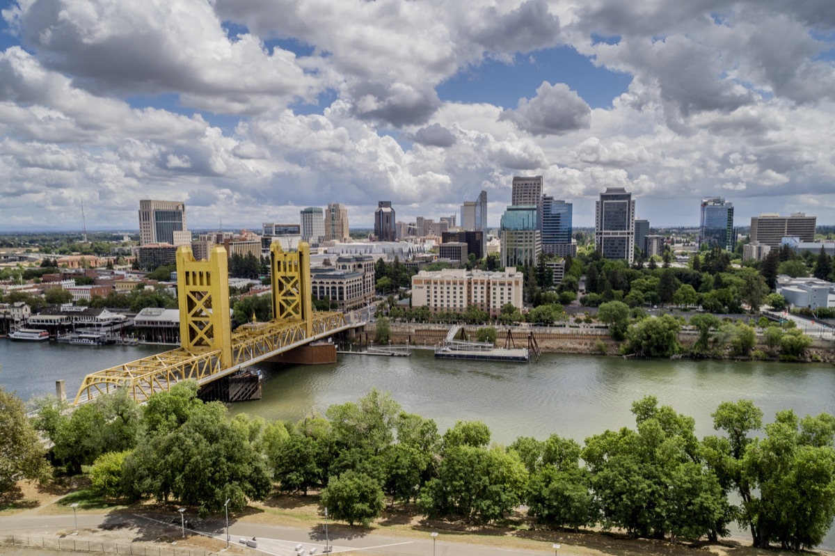 High quality stock aerial view photo of Sacramento's Tower Bridge and the Sacramento River, looking towards the Capitol mall and building.