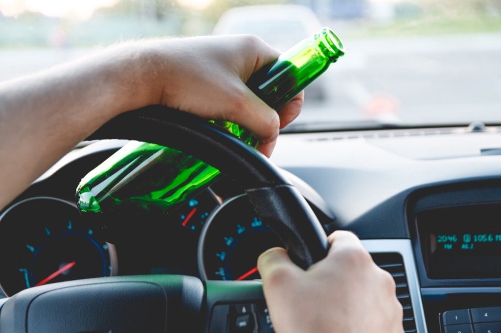 drunk driver holding beer bottle about to get dui