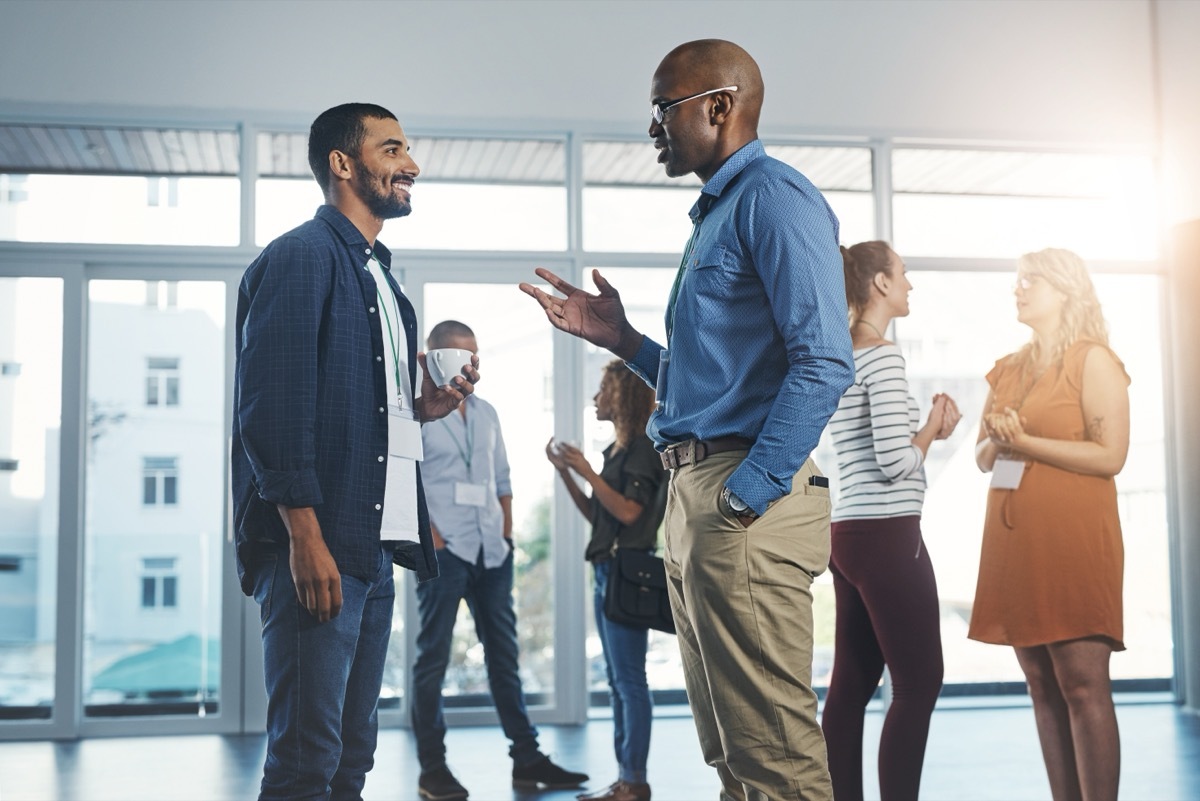 two men having a conversation at work