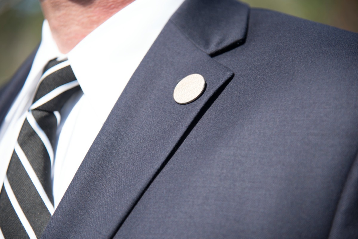 man wearing black tie and blue suit