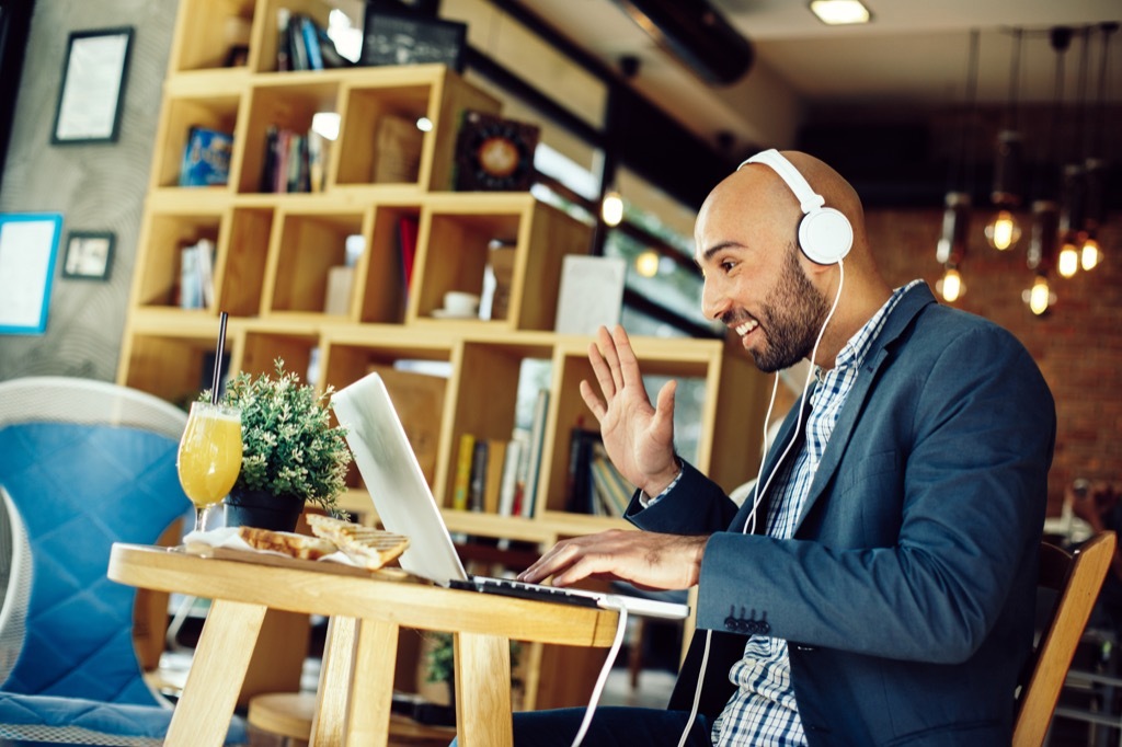 man in cafe on laptop skype facetime long-distance relationships