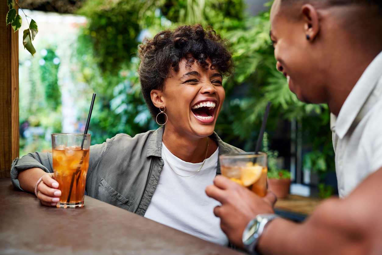 Shot of a happy young couple having drinks and relaxing together at an outdoor cafe