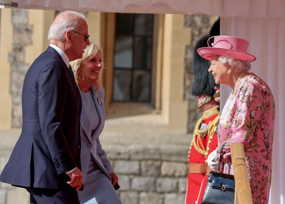 Britain's Queen Elizabeth II (R) greets US President Joe Biden (L) and US First Lady Jill Biden (C) at the dais in the Quadrangle of Windsor Castle in Windsor, west of London, on June 13, 2021.