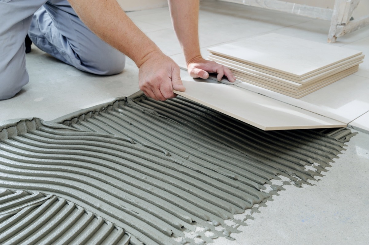 man adding tile floor to house, downgrade upgrades worst home upgrades