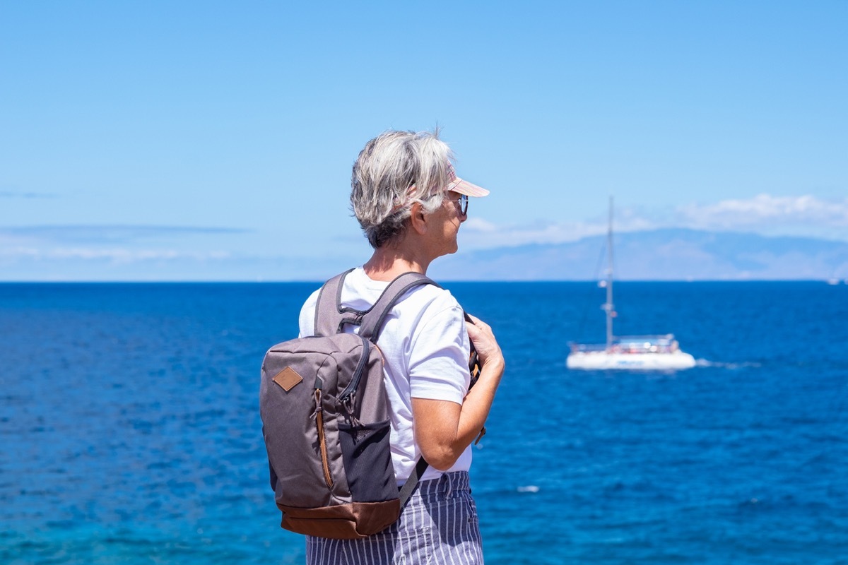 senior woman traveling wearing neutral top