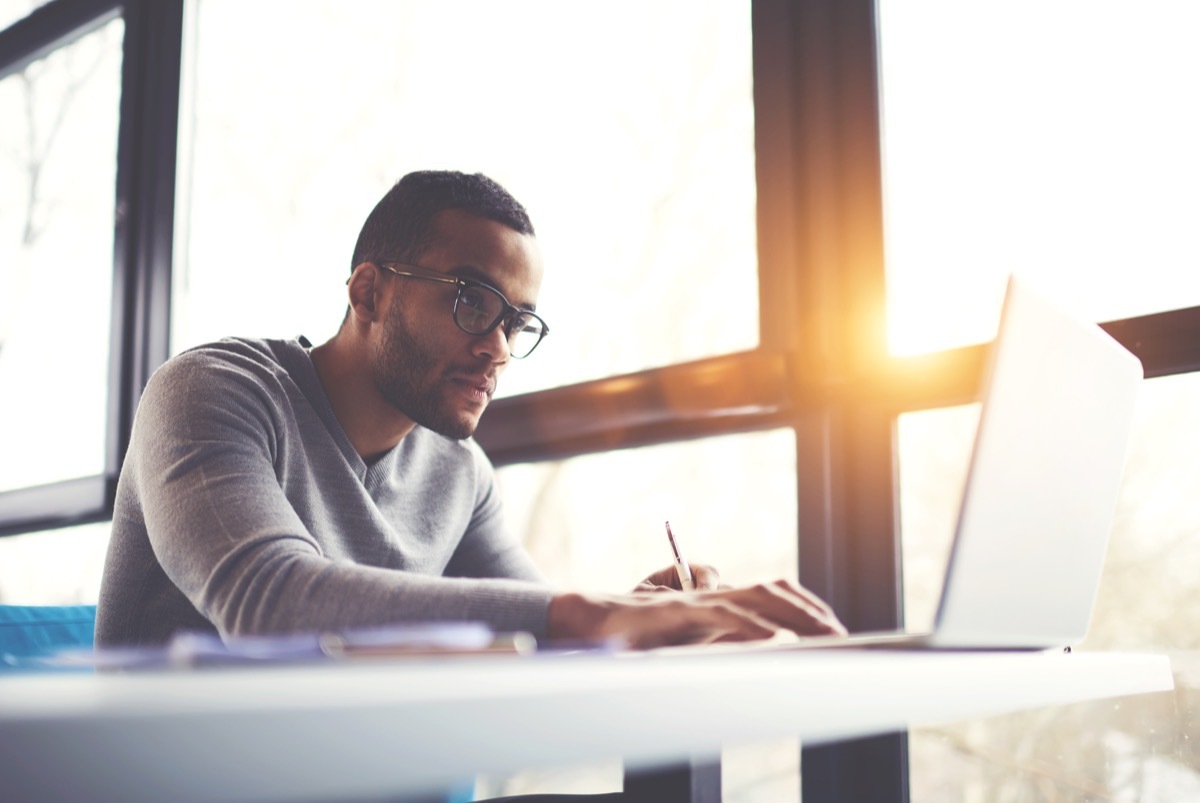 African American copywriter focusing at work