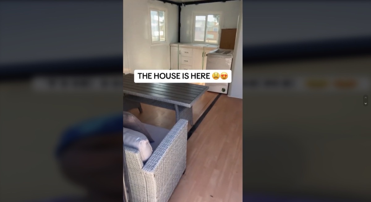 The interior of a tiny home purchased off of Amazon with a couch and kitchenette