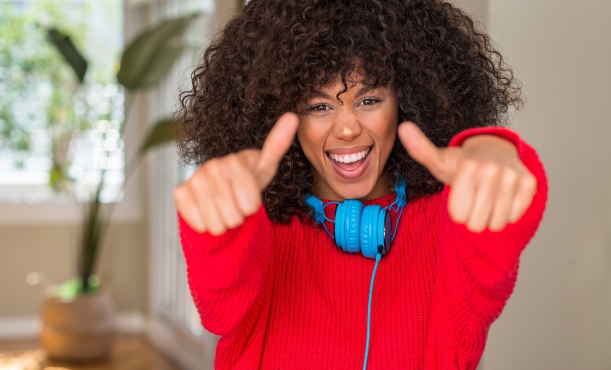 woman smiling with her thumbs up