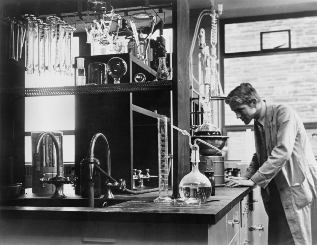 Scientist conducting a laboratory experiment in a cancer research facility in the United States, 1951.