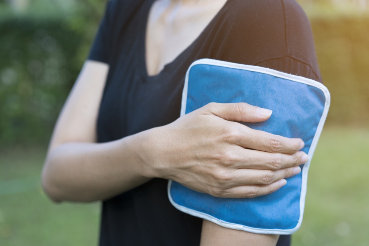 Woman applying compress after vaccine